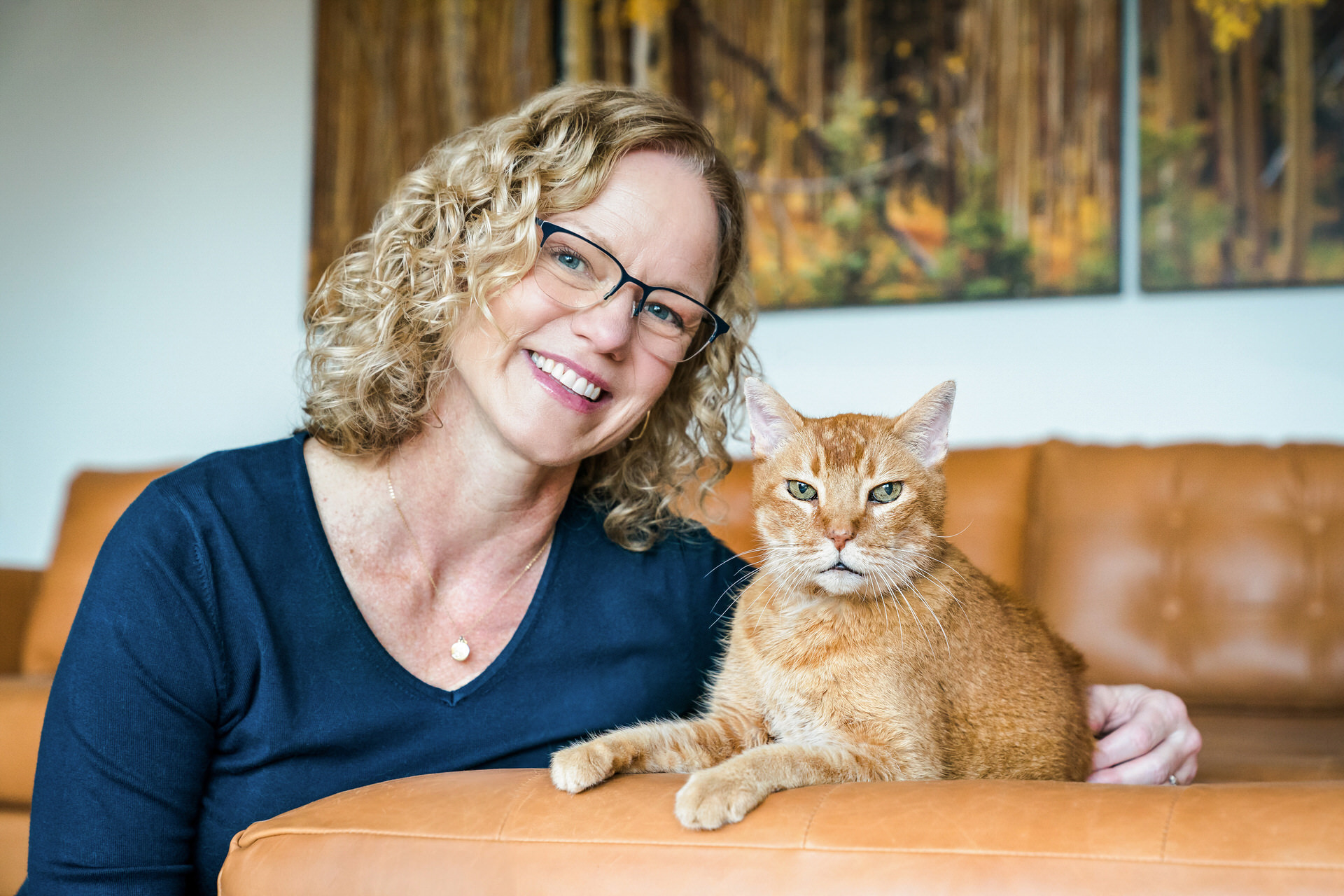 women poses with orange cat