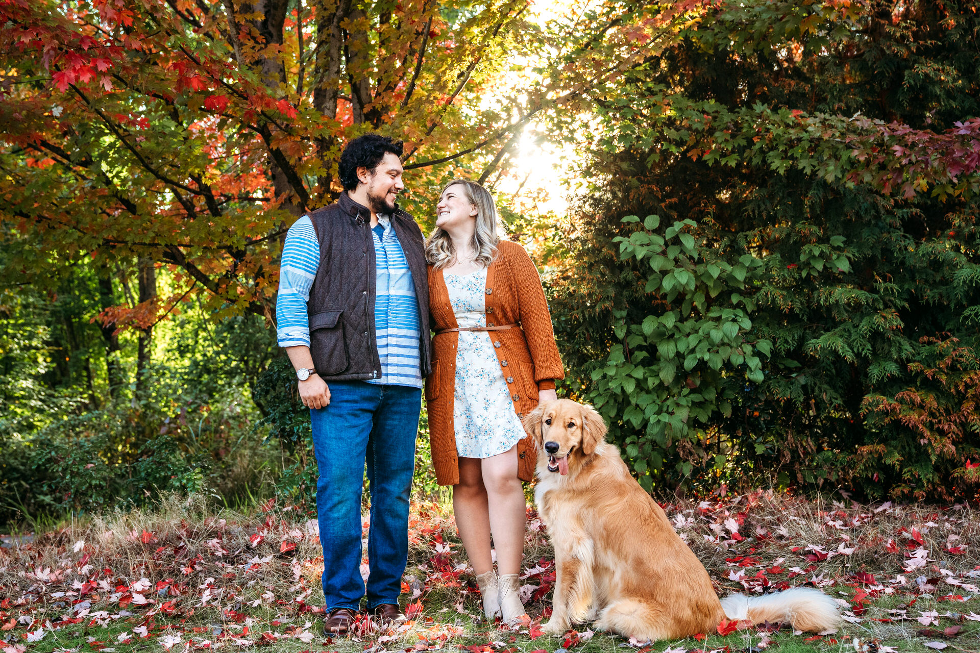couple with their dog at their fall photo session in Cathedral Park in North Portland.
