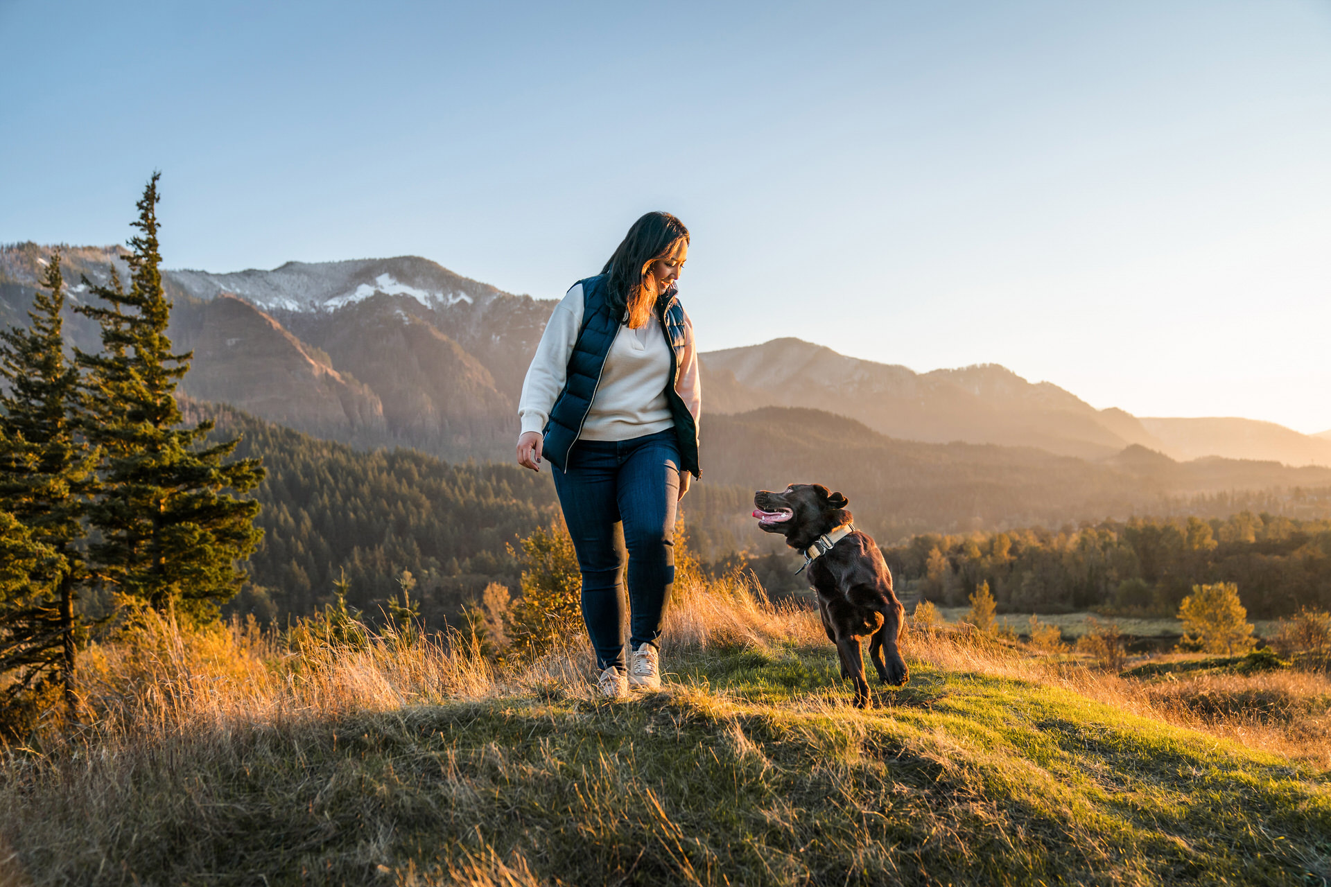 dog and woman play together with mountain views at their dog photography session in Oregon