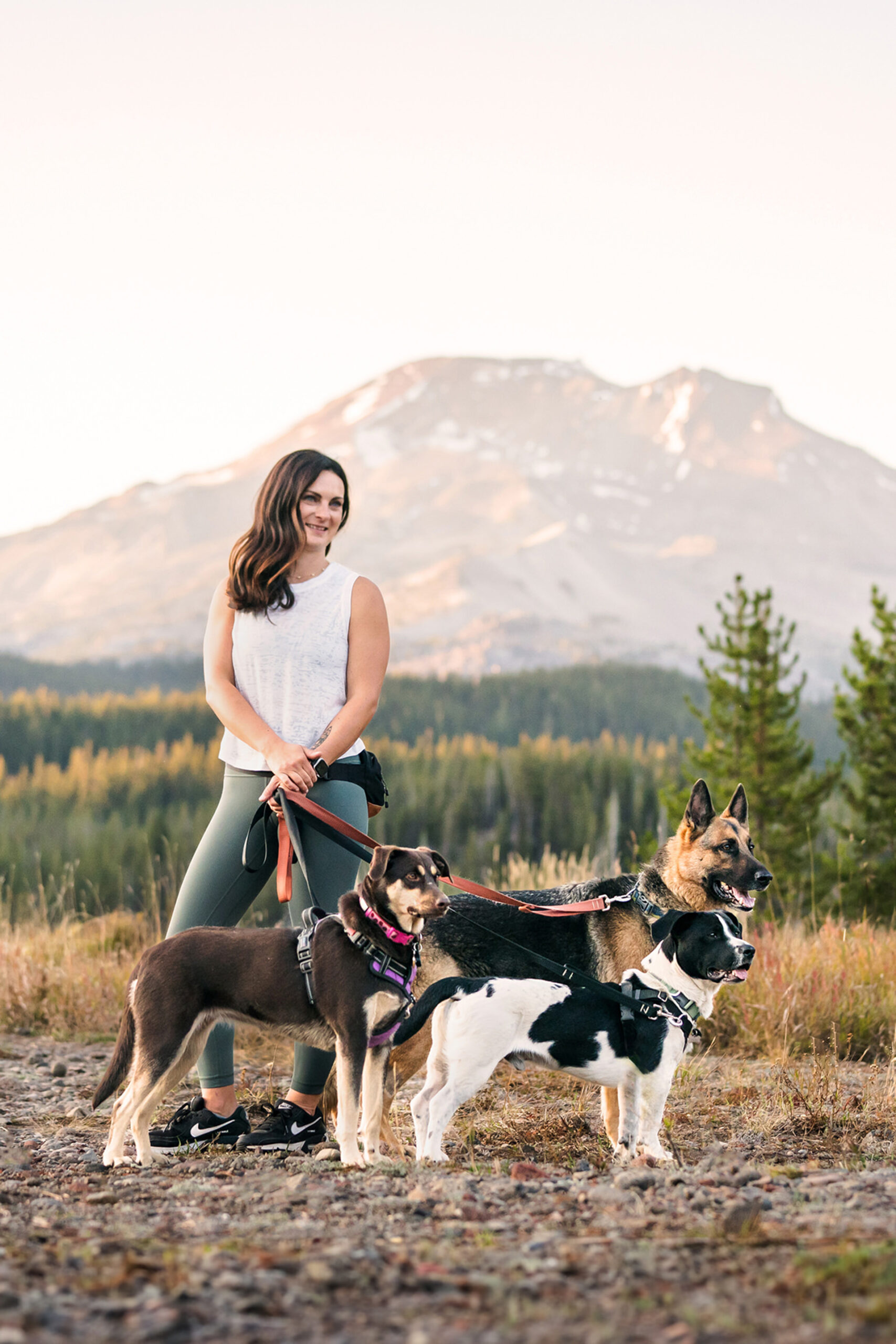 dog trainer in bend oregon stands with dogs