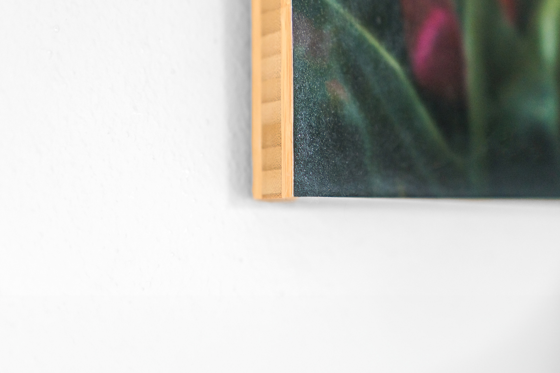 Close-up of canvas corner on white wall.