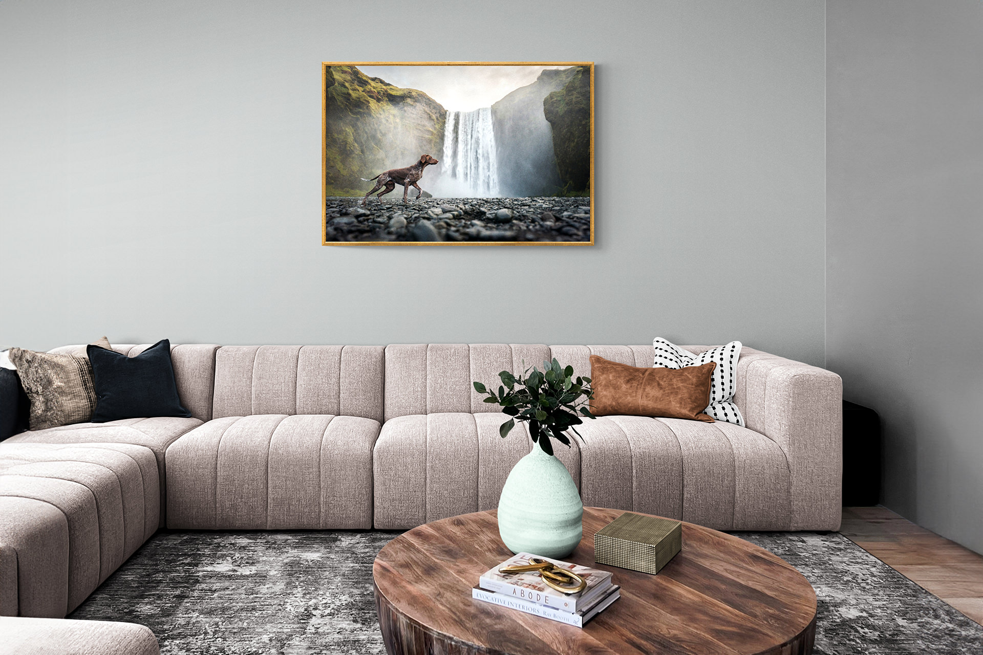 Modern living room with framed waterfall artwork.